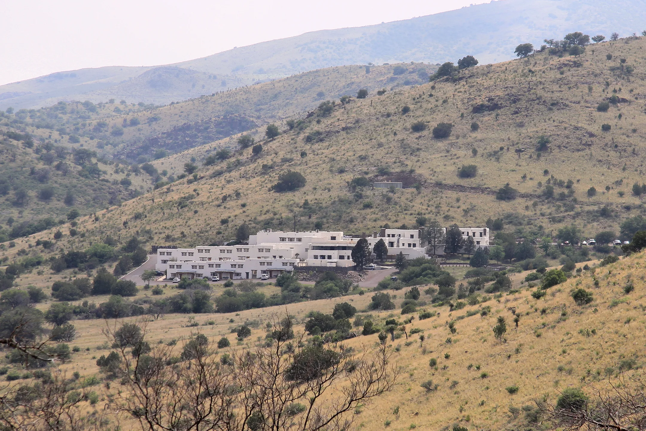 White adobe buildings of Indian Lodge beneath the Davis Mountains